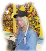 Barbara from Bulldog Leather smiling with the new pony tail caps she was sewing together. Barbara is right on Main Street, you can't miss her with her giant yellow patch boards