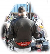 A Biker on Main Street with the Tribal Orange Harley Davidson patch sewed on his jacket