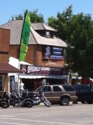 Sturgis Main Street A Green EyeQ Riding Glasses Flag hanging over Main St