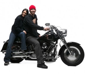 Portrait of a young couple sitting on a motorcycle