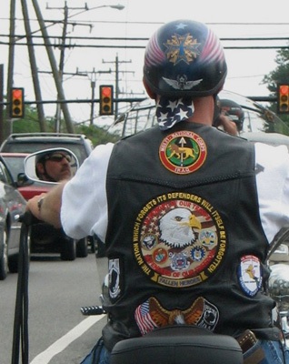vest biker riding on main street