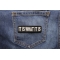 It Is What It Is Patch shown on jeans