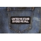 United We Stand Divided We Fall Patch shown on jeans