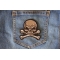 Gray Skull and Cross Bones Patch shown on jeans