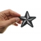 Black White Nautical Star Iron on Novelty Patch shown on hand for size comparison
