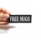 Free Hugs Patch | Embroidered Patches Free Hugs Naughty Iron on Patch shown on hand for size comparison