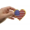 Gold Border Love US Flag Heart Patch shown on hand for size comparison