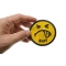 Shit Smiley Face Patch shown on hand for size comparison