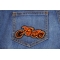 Triker Iron on Biker Patch In Orange and Black shown on jeans