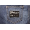 Biker Mom Patch In Old English shown on jeans