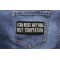 I Can Resist Anything But Temptation Patch shown on jeans