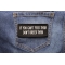 If You Can't Feed Them Don't Breed Them Iron on Morale Patch shown on jeans