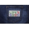 Life's Good White Green Red Blue Patch shown on jeans