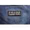 My Dog Is Cooler Than Most People Funny Iron on Patch shown on jeans
