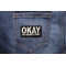 Okay But Wash It First Patch shown on jeans