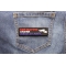 One Nation Under Surveillance Patch shown on jeans