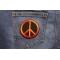 Peace Sign Patch Orange On Black shown on jeans