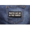 Practice Safe Sex Go Fuck Yourself Patch shown on jeans