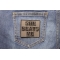 She Beats Me Patch shown on jeans