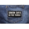 Simon Says Go Fuck Yourself Patch shown on jeans