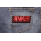 Sinner Patch | Embroidered Patches Sinner Patch shown on jeans