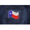 Texas Waving Flag White Border Patch shown on jeans