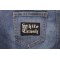 White Trash Patch In Old English shown on jeans