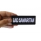 Bad Samaritan Funny Iron on Patch shown on hand for size comparison