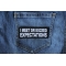 I Meet or Exceed Expectations Funny Iron on Patch shown on jeans