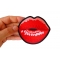 Kissing Lips Iron on Novelty Patch shown on hand for size comparison