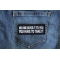 No One Gives it to You You have to Take It Patch shown on jeans