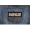 Shareholder Patch shown on jeans