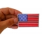 American Flag Reflective Patch shown on hand for size comparison