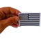 Subdued Black White US Flag Patch shown on hand for size comparison