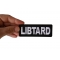 Libtard Funny Iron on Patch shown on hand for size comparison