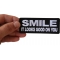 Smile It Looks Good on You Iron on Morale Patch shown on hand for size comparison