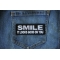 Smile It Looks Good on You Iron on Morale Patch shown on jeans