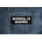 Normal is Boring Patch Normal is Boring Funny Iron on Patch shown on jeans