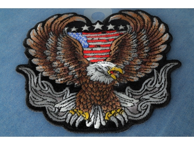 Up-winged biker eagle, with a portion of the American flag behind it
