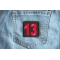 13 Patch Black Red Square 13 Patch shown on jeans