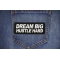 Dream Big Hustle Hard Patch shown on jeans