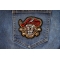 Deranged Jolly Roger Pirate Patch shown on jeans