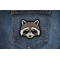 Funny Raccoon Iron on Patch shown on jeans