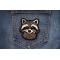 Cheeky Raccoon Iron on Patch shown on jeans