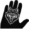 Wolf Stare Patch shown on hand for size comparison