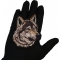 Wolf Patch shown on hand for size comparison