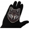 Wolf Patch shown on hand for size comparison