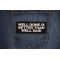 Well Done is Better Than Well Said Patch shown on jeans