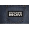 World's Okayest Mom Patch shown on jeans