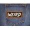 WEIRD Patch shown on jeans